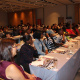Attendees at the workshop attentively listen as they start their training programme