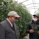 Byron Booysen showing minister Ivan Meyer a young tomato plant