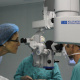 Dr Beth Engelbrecht, HOD for Western Cape Government Health, looks into the operating microscope during a cataract extraction operation. 