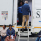 Civilians queue outside the mobile clinic for their turn to be medically assessed by doctors from the University of Cape Town