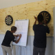 Eager competitors wrap up a dart game at the BTG Games in Caledon