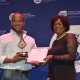 A representative from the The Chaeli Campaign receiving the award for Best Disability Project in the Visual Arts, Performing Arts and Literary Arts from Jane Moleleki