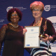 A representative from The Kusasa Project accepting the Neville Alexander Award for the Promotion of Multilingualism from Jane Moleleki