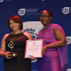 A representative from Adriaanse Public Library receiving an award for Best Medium Public Library from Nomaza Dingayo