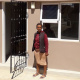 Ms Thandiswa Magadla a beneficiary from Mfuleni standing in front of her new house