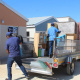 Trailer being unloaded as beneficiaries are moving in