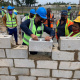 Front L – R: Western Cape Minister of Human Settlements, Tertuis Simmers and one of the women-owned sub-contractors, Ms Phumla Lombo, of Khollie & Sons Enterprise (SMME)