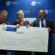 HWC Chris Snelling and Chairperson Antonia Malan receive the HWC payment from Guy Redman