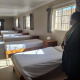 Minister Fernandez in one of the dorm rooms at Toevlug Centre