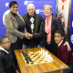 Mercia Sias and Cecil Cupido receiving the chess tables from Minister Anroux Marais.