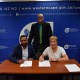 Minister Anroux Marais and Luschen Govender from Old Mutual sign the MOU as Chief Director Dr Lyndon Bouah looks on.