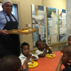 Minister Fritz serves lunch meals to cute ECD kids