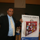 Minister Ivan Meyer accept the newly designed posters by Library Services.