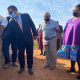 Minister Meyer being watched by PT Hahn and minister Didiza as he switches on the irrigation system