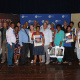 Officials from public libraries in the Mossel Bay area and the storytellers who participated in the initiative receive framed posters.