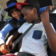 Provincial Traffic Inspector Antoinette Fennie ensures that Kgomotso Matsunyani is properly buckled up.