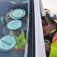 Road safety officer Jennifer Solomons places a sticker on a vehicle’s windscreen.