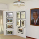 Some photos from the exhibit are seen next to a portrait of president Mandela in the lounge of the house