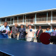 Table tennis players at the school were eager to use the equipment to their benefit, while dignitaries look on.
