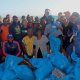 The team with the many bags of litter they collected from the beach.