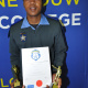 Traffic Officer Nande Mnqgibisa with his traffic diploma and two trophies.