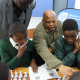 Watu Kobese using the isiXhosa Chess Book to explain chess principles to the learners.