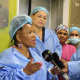 Minister Mbombo briefing the media outside the theatre rooms in which a live robotic surgery was taking place.
