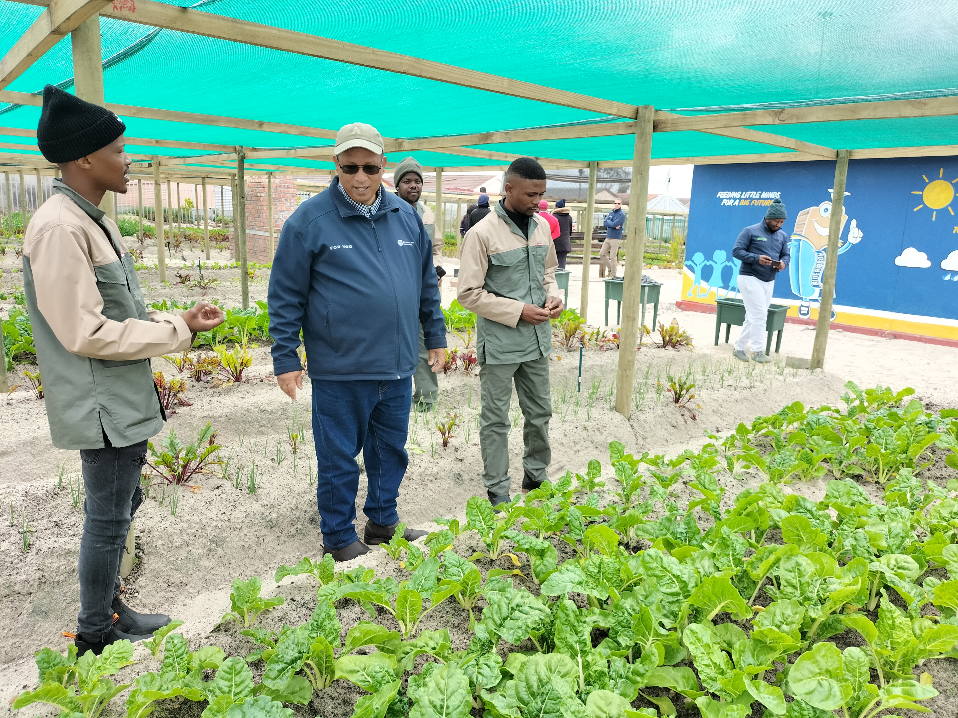 Thapelo  Xabanisa and Baluleka Xabanisa showing  Minister Meyer the spinach patch