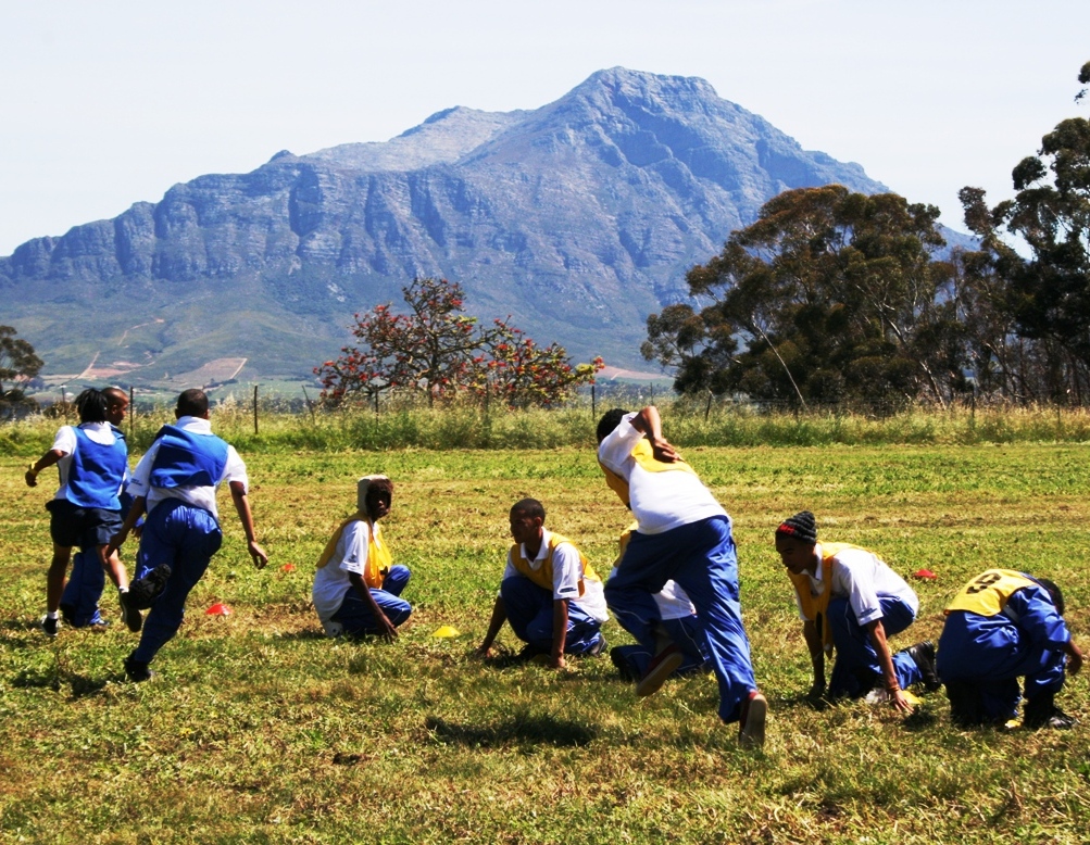 The youth participating in Dibele on the camp sports field