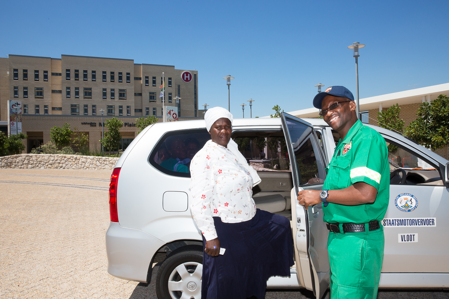 EMS driver Nohani Themelani assists Noluvuyo Mazwayi of Philippi into the new patient transport vehicle.