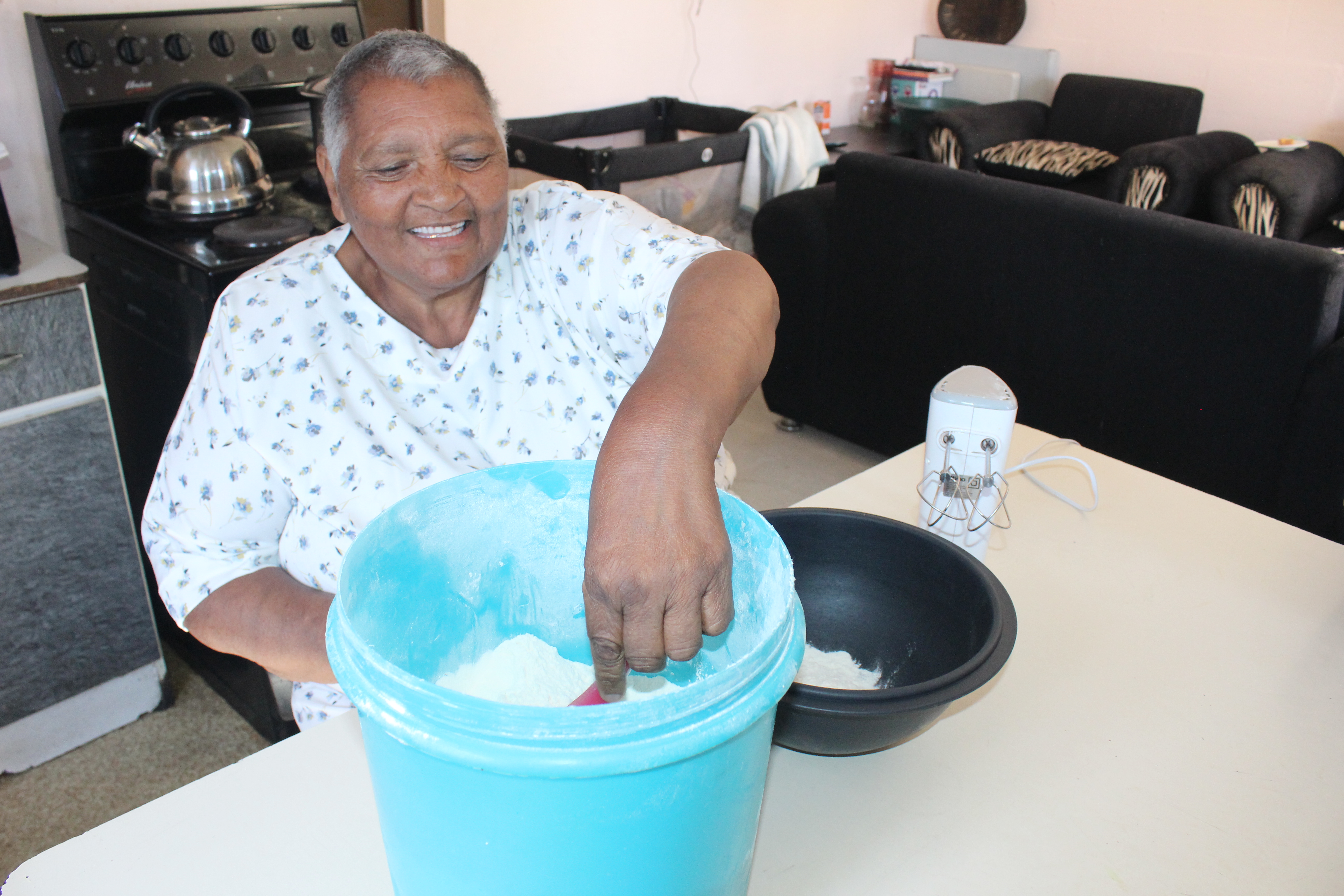 Mildred Swanepoel in her happy place, baking again for her community after suffering a stroke a year ago.