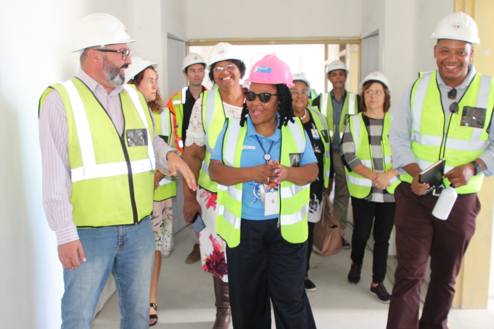 Minister Mbombo touring the construction site to inspect the progress being made with the contractors, civil society and political representatives.