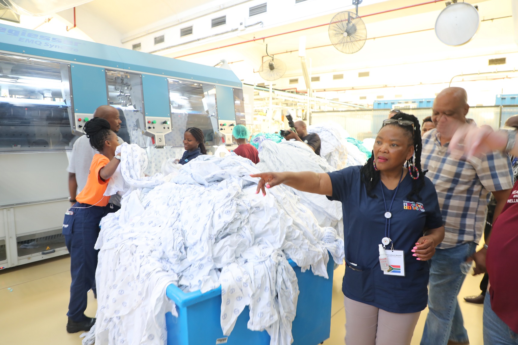 Minister Mbombo inspecting the new washing lines and machines which formed part of the Central Laundry revitalisation.