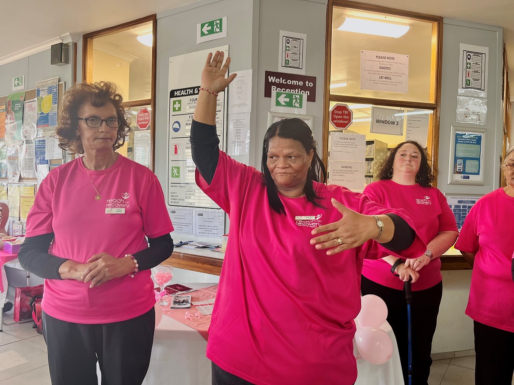 Breast cancer survivor Yolanda Barry demonstrates how to do a breast cancer inspection. She has been cancer free for 11 years.
