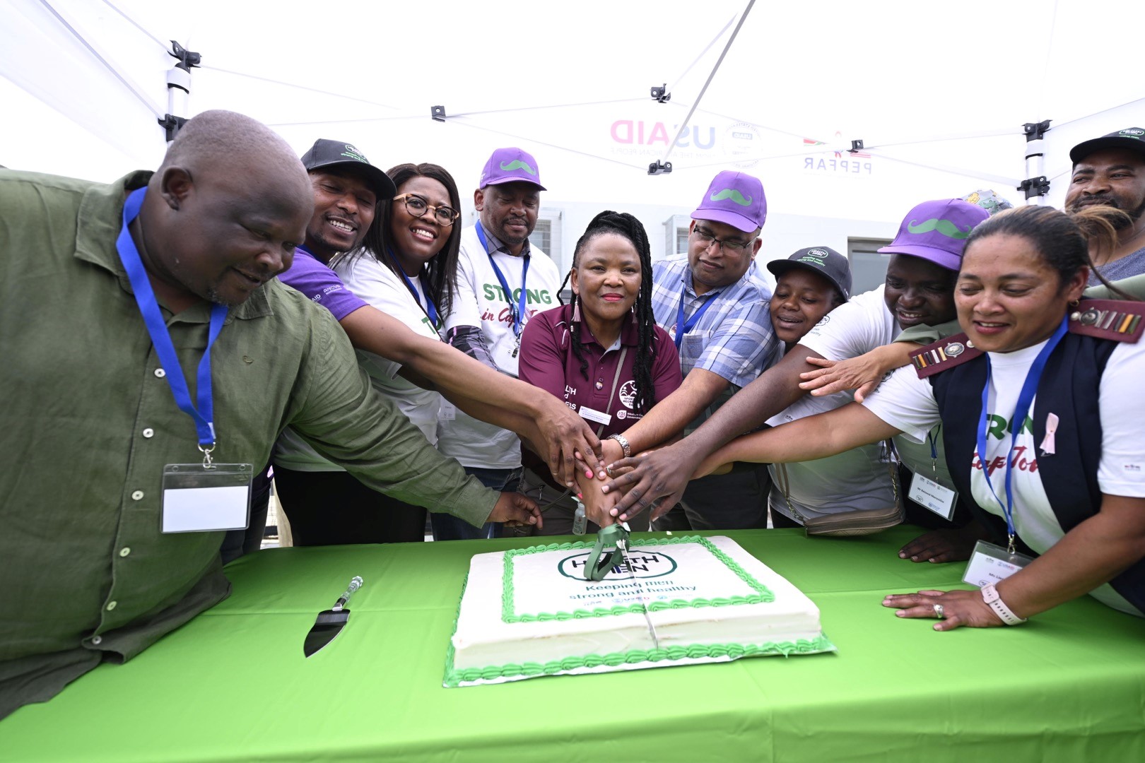 Dr Nomafrench Mbombo, joined by Anova, pictured during a cake cutting ceremony at the opening of the dedicated men’s health service at Fisantekraal on 2 November 2023.