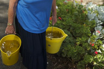 woman carrying buckets of water 